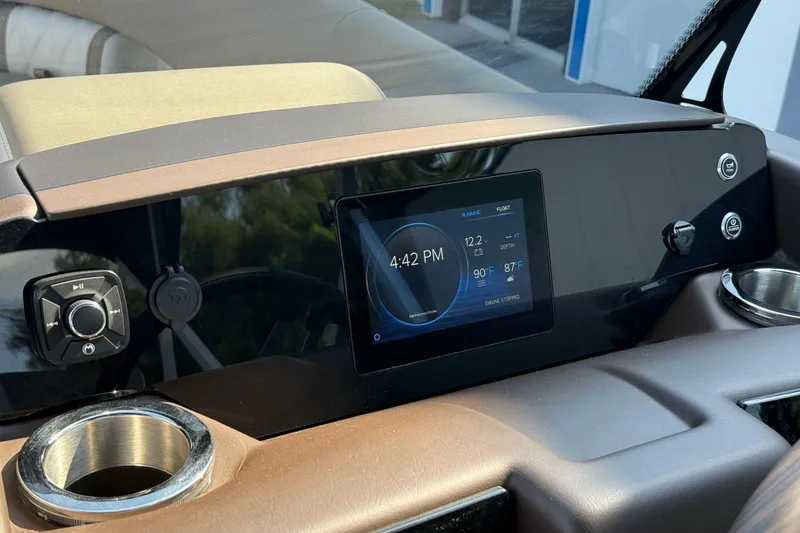 Slide: The Image of 2025 Bennington 23 LXSFB dashboard with digital display and control panel. - 24