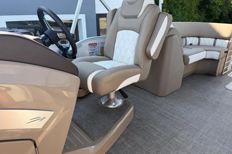 Slide: The Image of 2025 Bennington 23 LXSFB boat interior with luxurious seating and modern steering wheel. - 30
