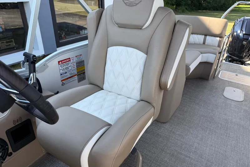 Slide: The Image of 2025 Bennington 23 LXSFB boat interior with luxurious seating and steering wheel. - 31