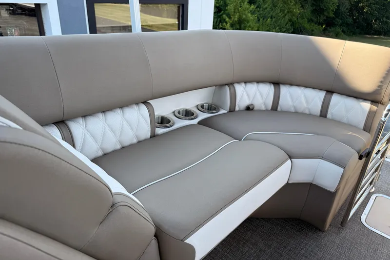 Slide: The Image of 2025 Bennington 23 LXSFB boat interior with plush seating and cup holders. - 32