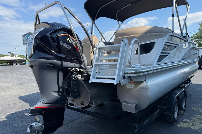 Slide: The Image of 2025 Bennington 23 LXSFB pontoon boat with Yamaha outboard motor on trailer. - 7
