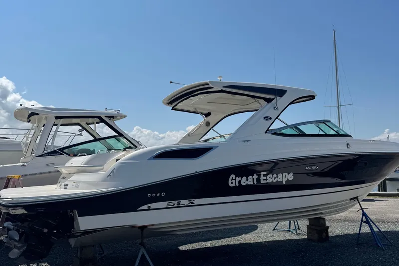 Slide: The Image of 2016 Sea Ray 350 SLX boat named "Great Escape" on display, side view. - 0