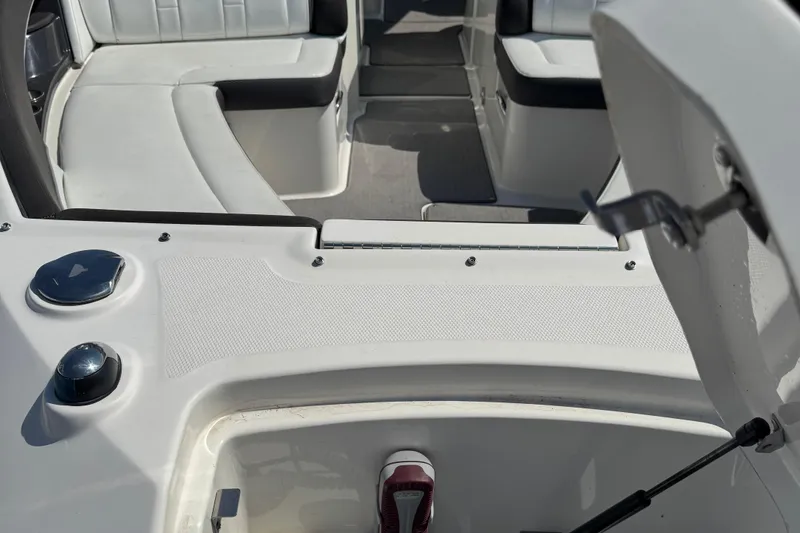 Slide: The Image of 2016 Sea Ray 350 SLX boat interior with white seating and open storage compartment. - 1