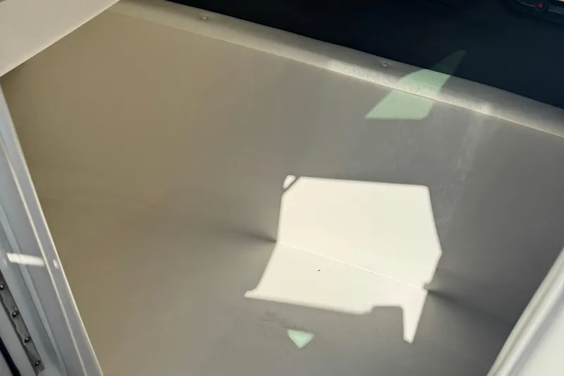 Slide: The Image of Storage compartment inside 2016 Sea Ray 350 SLX boat, featuring clean, spacious interior. - 10