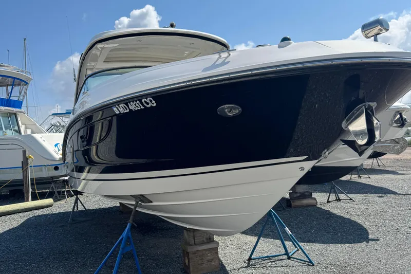 Slide: The Image of 2016 Sea Ray 350 SLX boat on stands, displayed outdoors under a clear sky. - 11