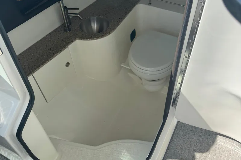 Slide: The Image of 2016 Sea Ray 350 SLX boat bathroom with sink and toilet. - 12