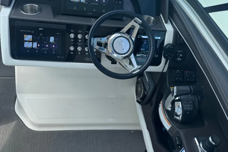 Slide: The Image of 2016 Sea Ray 350 SLX helm with modern controls and navigation displays. - 15