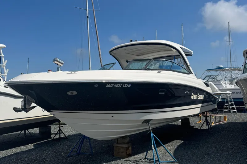 Slide: The Image of 2016 Sea Ray 350 SLX boat on stands, clear sky background. - 19