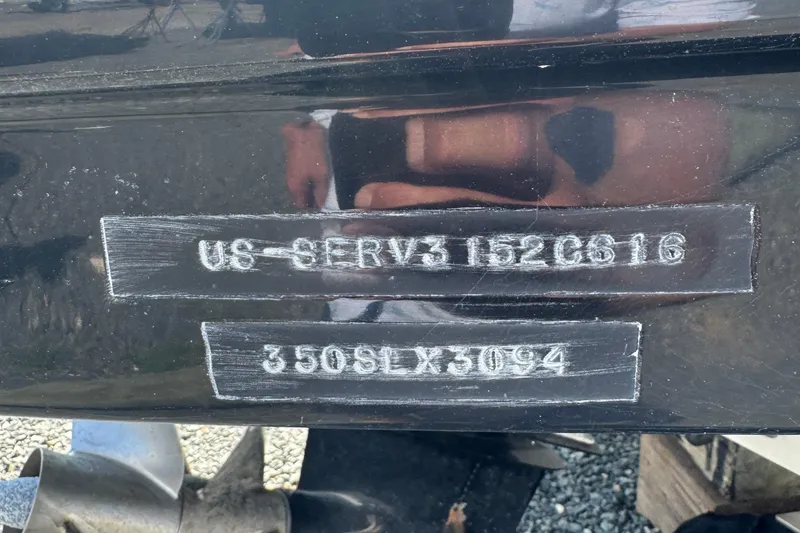 Slide: The Image of 2016 Sea Ray 350 SLX hull identification number and model details on black surface. - 2