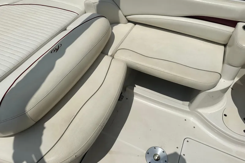 Slide: The Image of 2007 Monterey 263 Explorer Deck Boat interior seating, featuring white cushioned seats. - 10