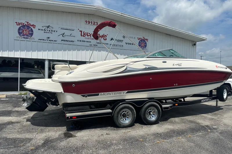 Slide: The Image of 2007 Monterey 263 Explorer Deck Boat on trailer, parked outside dealership. - 3