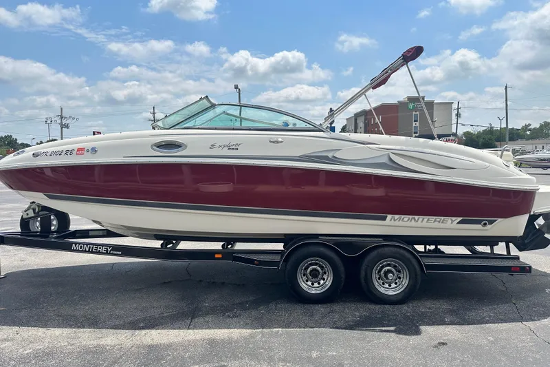 Slide: The Image of 2007 Monterey 263 Explorer Deck Boat on trailer, red and white design, parked outdoors. - 5