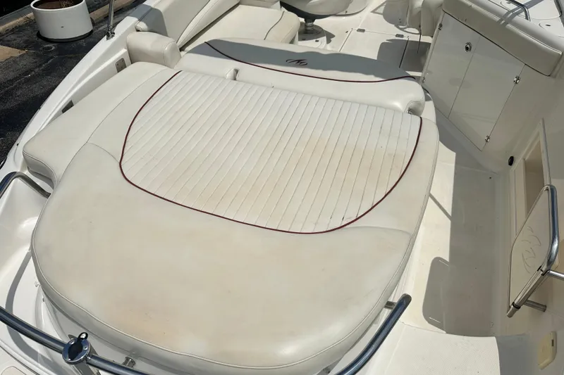 Slide: The Image of 2007 Monterey 263 Explorer Deck Boat interior with white cushioned seating. - 8