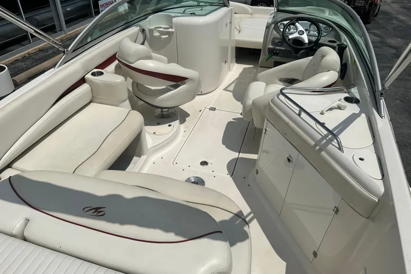 Slide: The Image of 2007 Monterey 263 Explorer Deck Boat interior with white seating and steering console. - 9