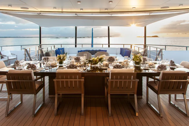 Slide: The Image of Luxurious dining setup on Alia Yachts 60M, 2016 model, with ocean sunset view. - 18