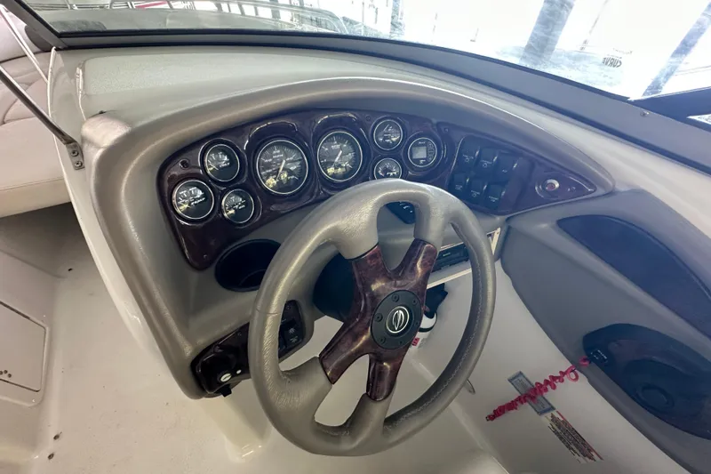 Slide: The Image of 2005 Crownline 270 BR boat dashboard with steering wheel and instrument panel. - 19