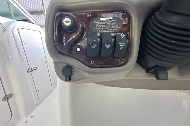 Slide: The Image of Control panel of a 2005 Crownline 270 BR boat with switches and warning label. - 21