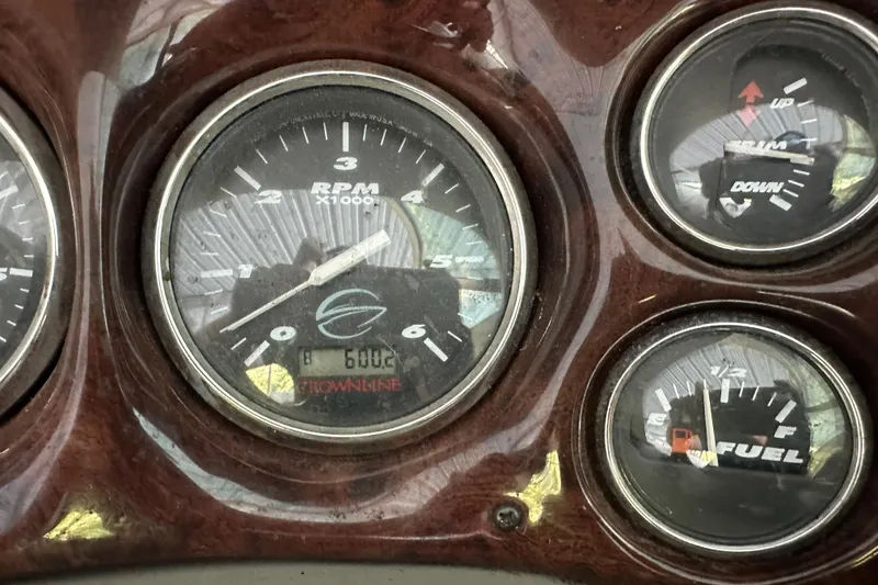Slide: The Image of Dashboard of a 2005 Crownline 270 BR boat showing RPM, trim, and fuel gauges. - 22