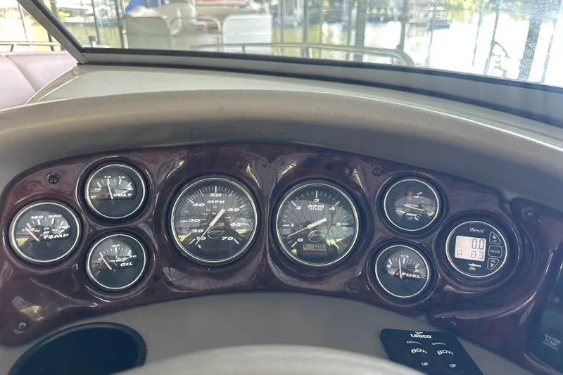 Slide: The Image of Dashboard of a 2005 Crownline 270 BR boat with various gauges and controls. - 23