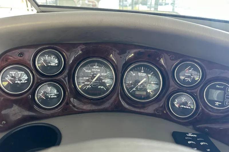 Slide: The Image of Dashboard of a 2005 Crownline 270 BR boat with various gauges and controls. - 24