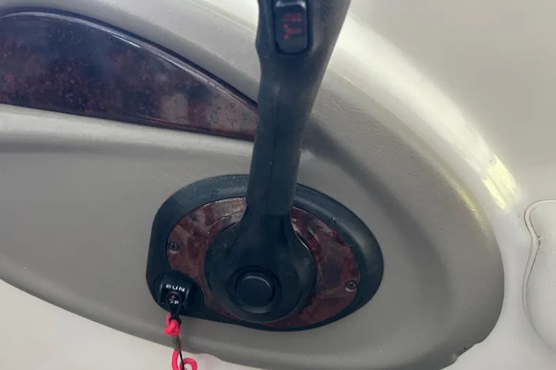 Slide: The Image of Throttle control lever on a 2005 Crownline 270 BR boat dashboard. - 25