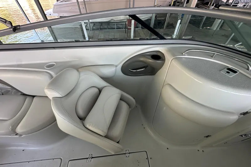 Slide: The Image of Interior of 2005 Crownline 270 BR boat with white seating and dashboard. - 30