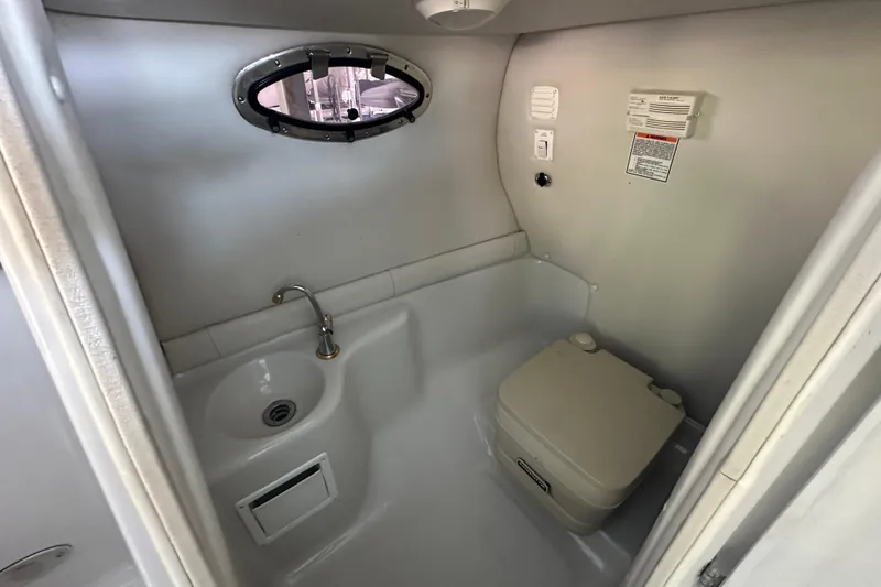 Slide: The Image of 2005 Crownline 270 BR boat bathroom with sink and portable toilet. - 31