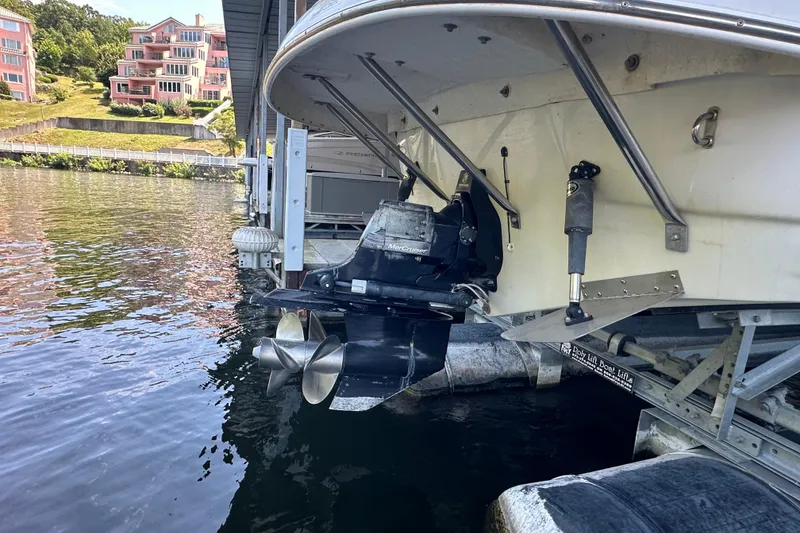 Slide: The Image of 2005 Crownline 270 BR boat docked, showing propeller and stern drive system. - 33