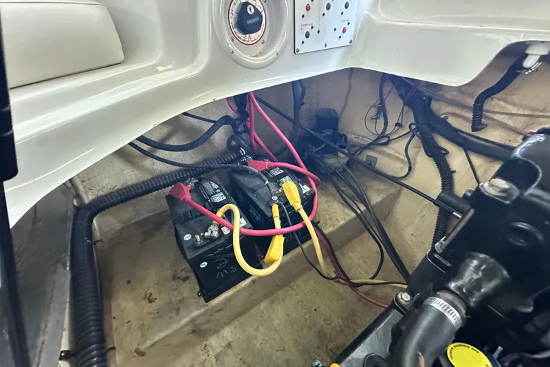 Slide: The Image of 2005 Crownline 270 BR boat battery compartment with wiring and connections. - 36