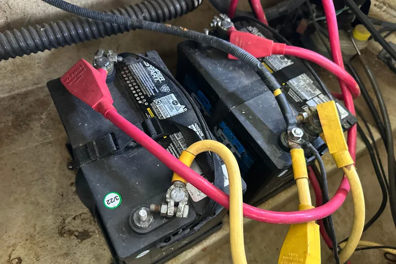 Slide: The Image of Batteries with red and yellow cables in a 2005 Crownline 270 BR boat. - 37