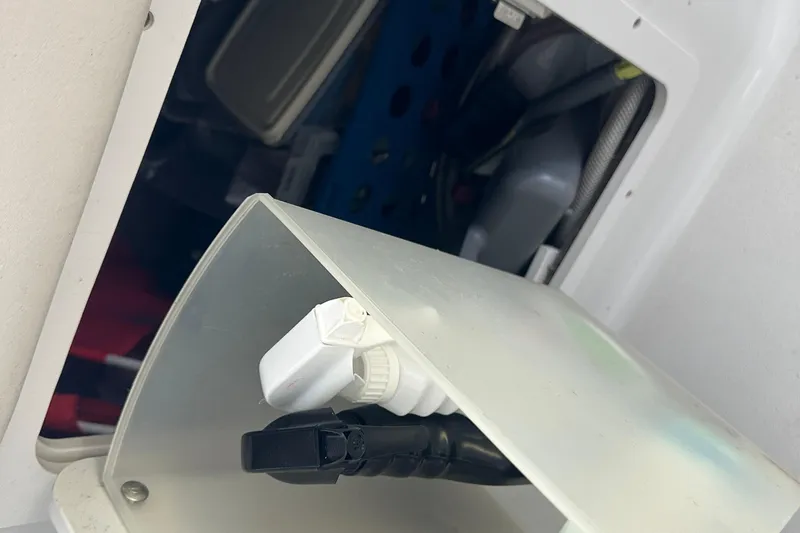 Slide: The Image of Storage compartment in a 2005 Crownline 270 BR boat, showing various equipment. - 38