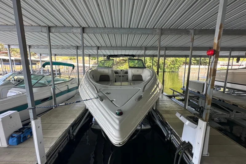 Slide: The Image of 2005 Crownline 270 BR boat docked in a covered marina slip. - 4