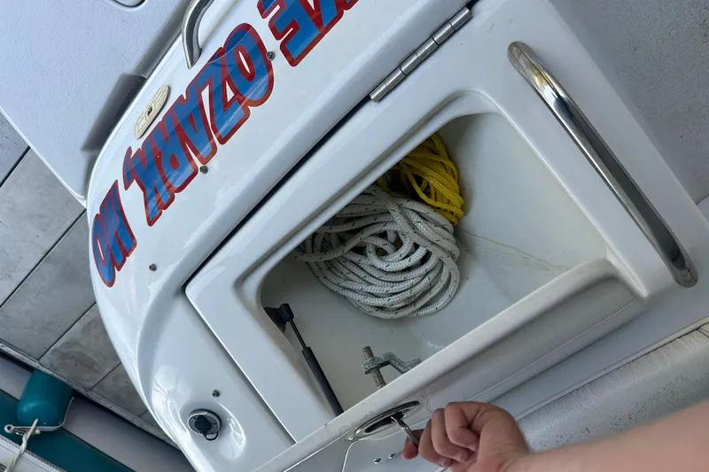 Slide: The Image of 2005 Crownline 270 BR boat storage compartment with ropes and handle. - 40