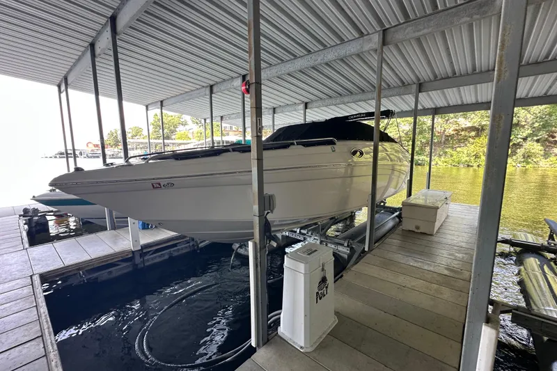 Slide: The Image of 2005 Crownline 270 BR boat docked in a covered marina slip. - 5