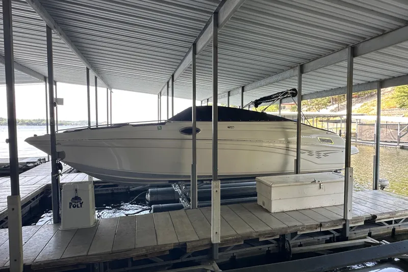 Slide: The Image of 2005 Crownline 270 BR boat docked under covered marina. - 6
