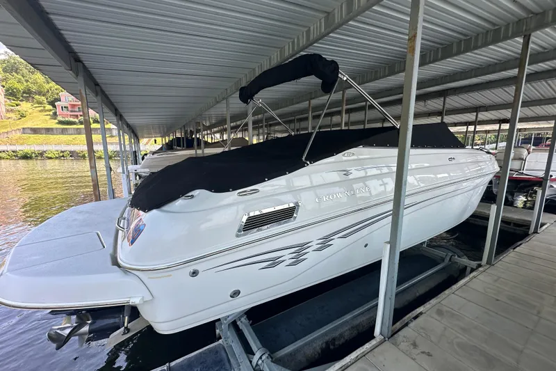 Slide: The Image of 2005 Crownline 270 BR boat docked under covered marina. - 9