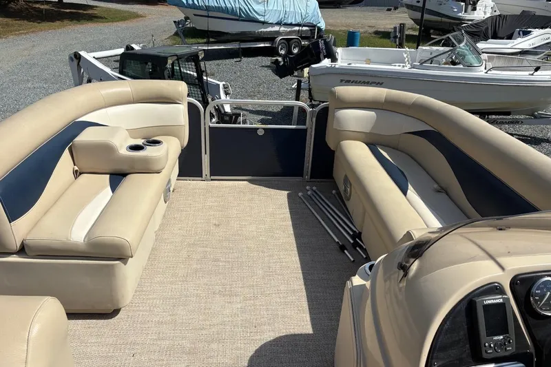 Slide: The Image of 2016 Godfrey SWEETWATER 2086 pontoon boat interior with beige seating and cup holders. - 4