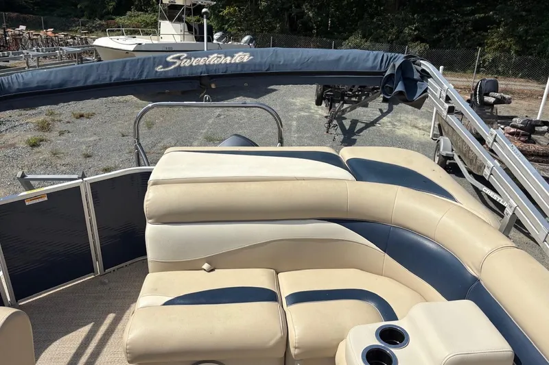 Slide: The Image of 2016 Godfrey SWEETWATER 2086 pontoon boat with beige and blue seating, docked outdoors. - 6