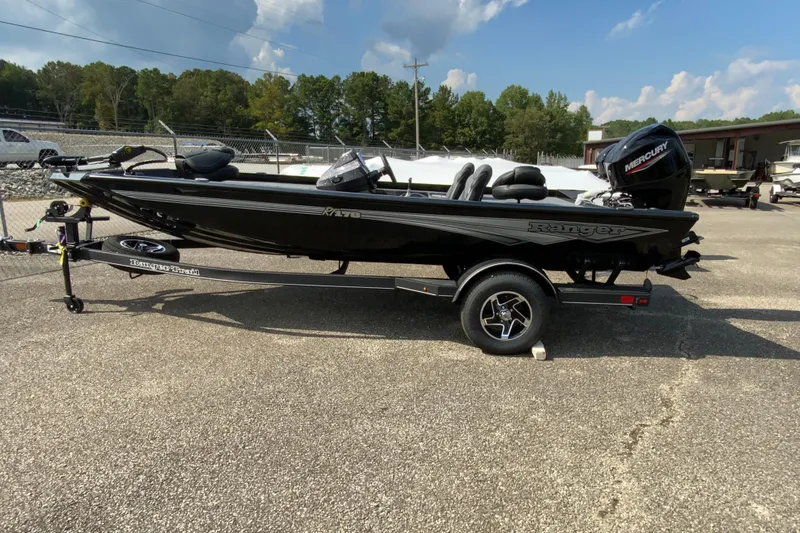 The Image of 2026 Ranger RT178 boat on trailer, black exterior, parked outdoors under blue sky. - 0
