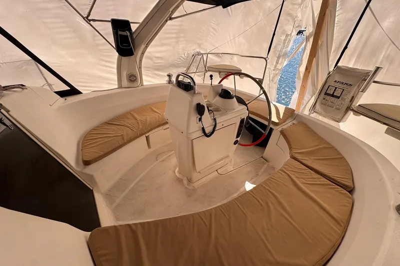 Slide: The Image of Interior of a 1997 Hunter 340 sailboat with cushioned seating and steering wheel. - 11