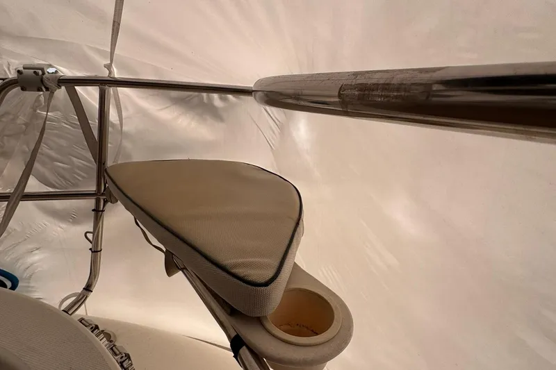 Slide: The Image of Interior view of a 1997 Hunter 340 sailboat with cushioned seating and metal railings. - 13