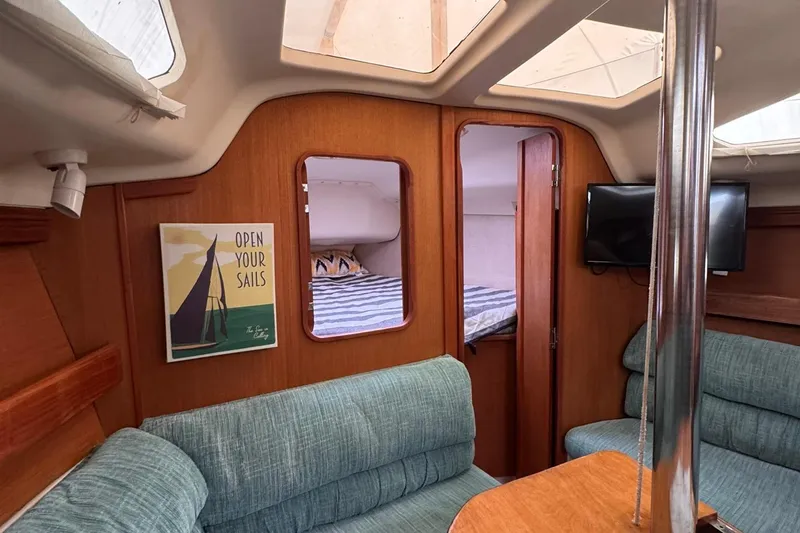 Slide: The Image of Interior of 1997 Hunter 340 sailboat with cozy seating and nautical decor. - 5