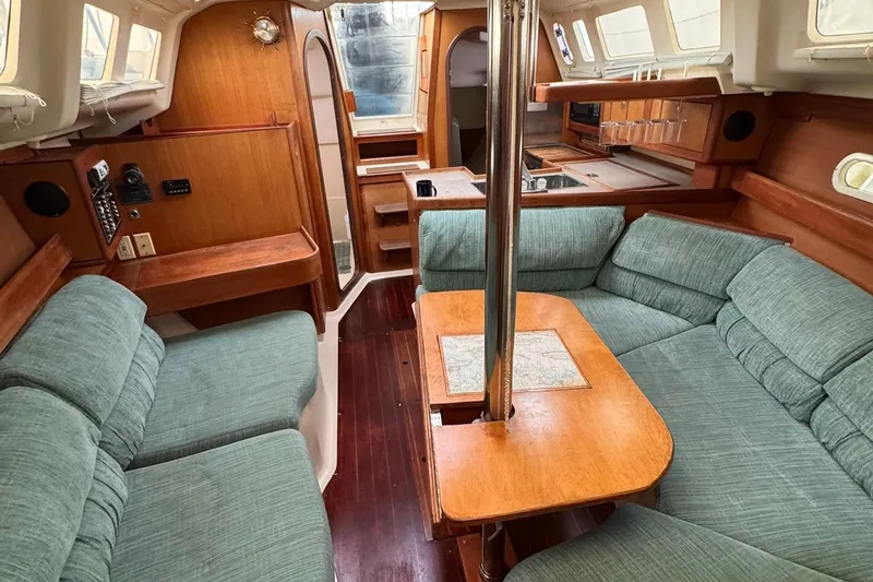 Slide: The Image of Interior of a 1997 Hunter 340 sailboat with cozy seating and wooden finishes. - 6