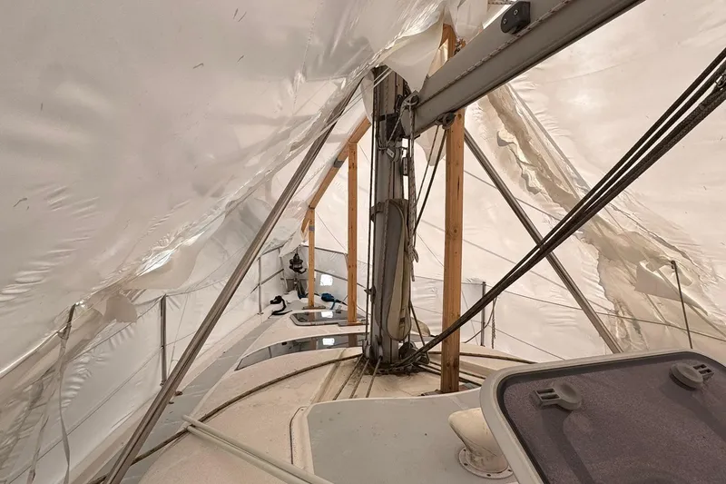 Slide: The Image of 1997 Hunter 340 sailboat under protective cover, showcasing mast and rigging. - 9