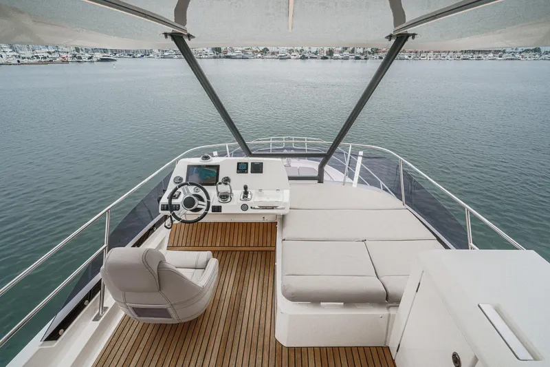 Slide: The Image of Flybridge of 2021 Prestige 420 Fly yacht with helm station and seating area. - 19