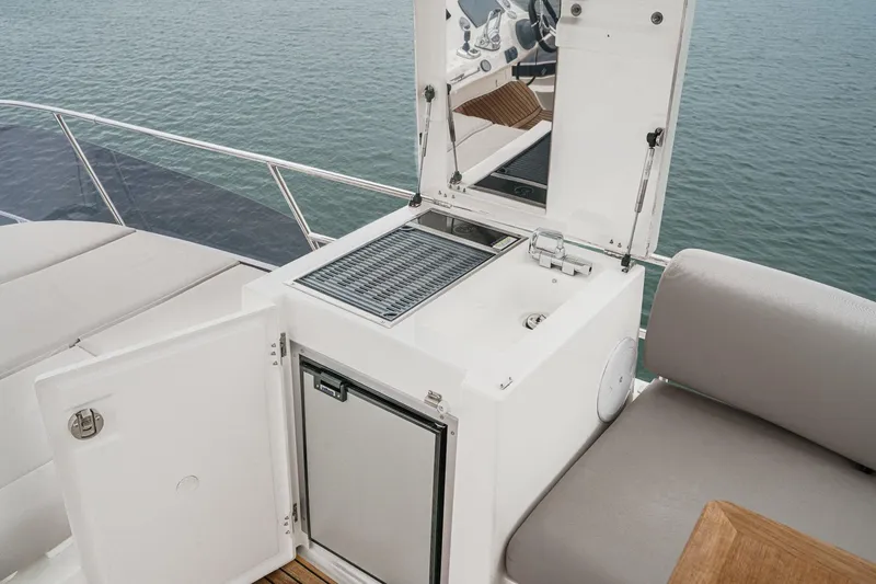 Slide: The Image of Outdoor kitchenette on 2021 Prestige 420 Fly yacht with grill and mini-fridge. - 23
