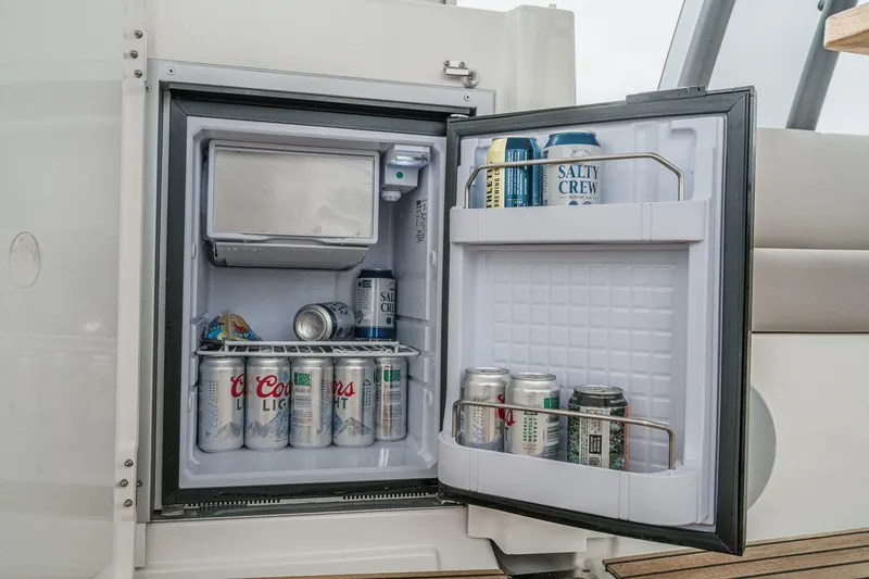 Slide: The Image of Mini fridge stocked with beverages on a 2021 Prestige 420 Fly yacht. - 25