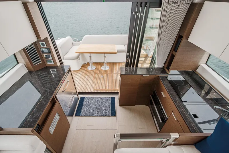Slide: The Image of Luxurious interior of 2021 Prestige 420 Fly yacht with modern kitchen and outdoor seating area. - 37