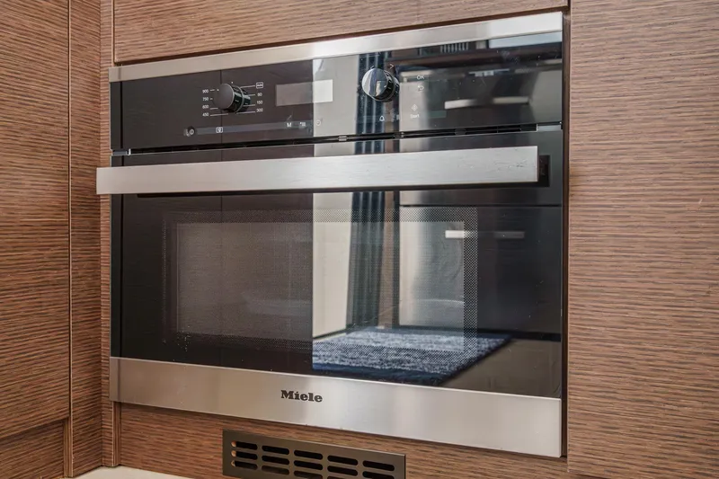 Slide: The Image of Miele oven in 2021 Prestige 420 Fly yacht kitchen, featuring sleek design and modern controls. - 43
