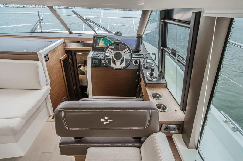 Slide: The Image of Interior helm of 2021 Prestige 420 Fly yacht with modern controls and seating. - 52